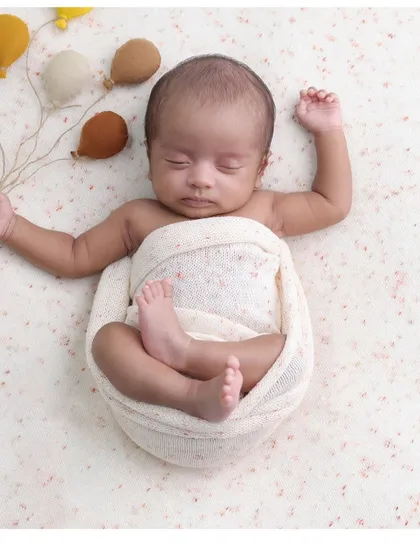 A neutral-toned version of our balloon theme. The earthy colors of the balloons complement the baby's skin tone beautifully in this simple swaddled shot.