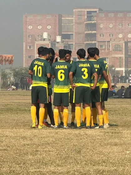 A moment of unity. The team gathers for a strategic huddle, reinforcing our philosophy of playing as one cohesive unit.