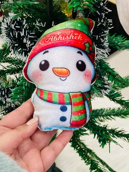 A close-up of the personalised snowman plush ornament, showing the soft texture and cute design.