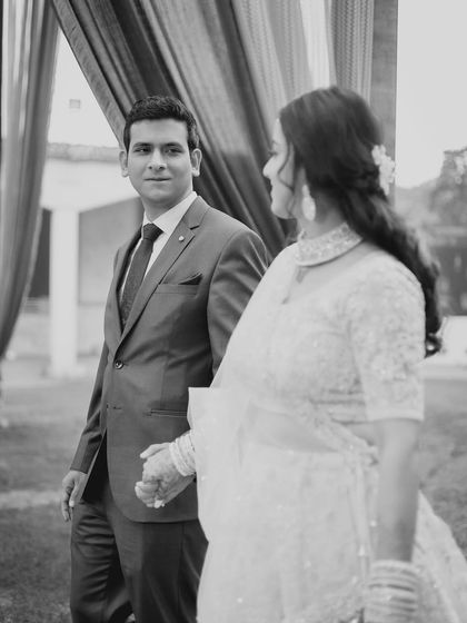 Another black and white candid, capturing a look of love between the couple.
