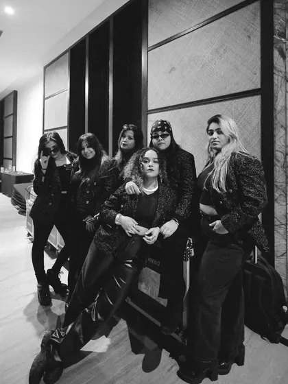 This is the squad. Sunshine mixed with a little hurricane. Backstage before a show, this black and white shot captures the bond and the fierce energy of the talented women who make up Womaniya.