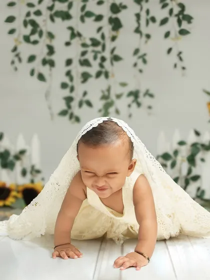 A playful game of peek-a-boo under a lace blanket. I encourage these simple, fun interactions to bring out the most genuine expressions and scrunched-nose smiles.