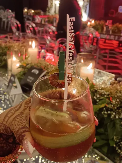 The little details matter. We offer personalized drink stirrers with your wedding hashtag, like this 'EastSaysYesToWest' stirrer, making every cocktail a part of your story.
