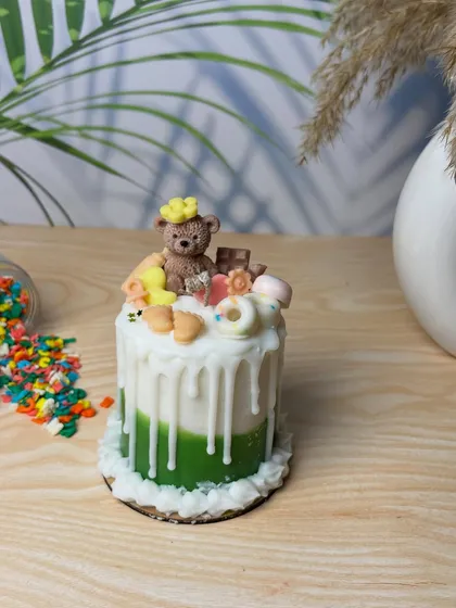 One of my bestsellers, this cake candle is topped with a teddy bear and other sweet treats. It's a popular choice for birthdays and baby showers.