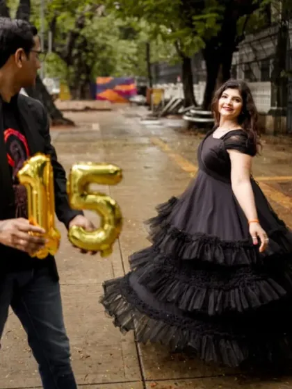 Celebrate your anniversary in style. This black tiered ruffle gown is a dramatic and beautiful choice for a special photoshoot.