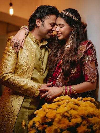 A sweet, close-up moment of the couple surrounded by marigolds, their expressions full of love and contentment.