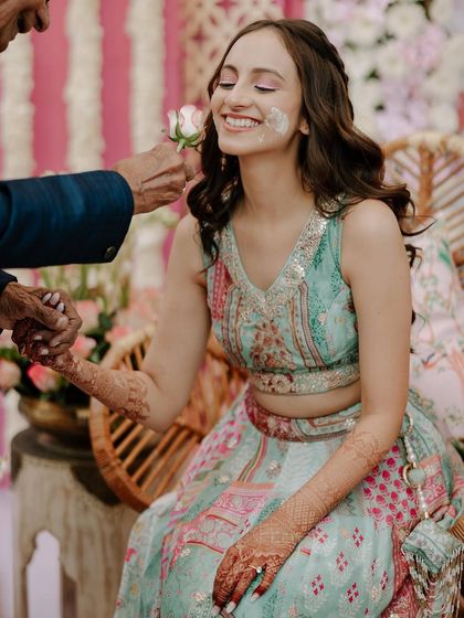 A sweet moment during the Haldi where a flower is used to apply the paste. It's these gentle, loving interactions that I love to document.