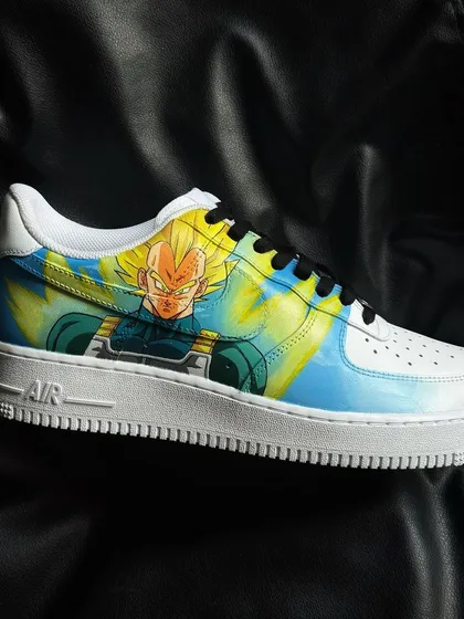A side profile of the custom Vegeta sneaker, showing the vibrant yellow aura and detailed character art.