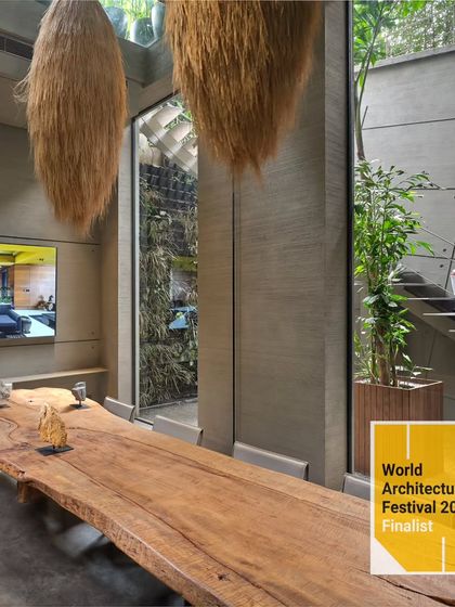 Another shot from our WAF finalist presentation, this image shows the seamless integration of indoor and outdoor spaces. The large wooden conference table is set against a view of the internal courtyard and green wall, embodying our biophilic design principles.