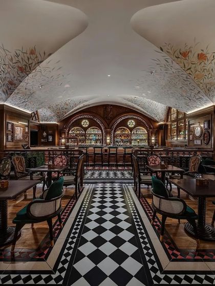 The vaulted ceiling and symmetrical layout create a grand, cathedral-like feel in the main space of the pub.