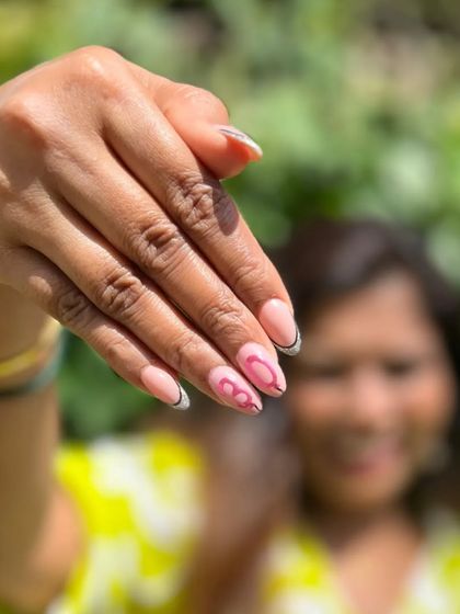 A fun, dynamic shot of the birthday girl showing off her custom nail art.