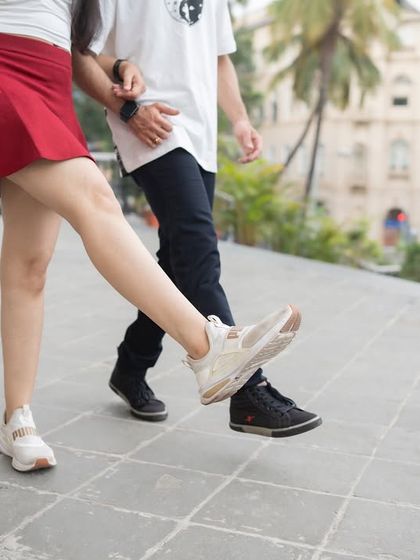 A fun, close-up shot of a couple's synchronized steps. This focuses on the small, quirky details that make a pre-wedding shoot unique and personal.