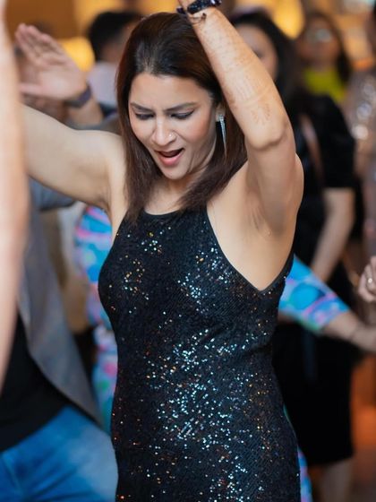 This is how we party at Perissa. A guest dancing with henna on her hands, showing the diverse crowds at my events.