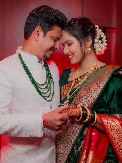 An intimate portrait of a newly engaged couple in Dombivli. Dressed in stunning traditional Maharashtrian attire, they share a quiet, happy moment, their hands intertwined.