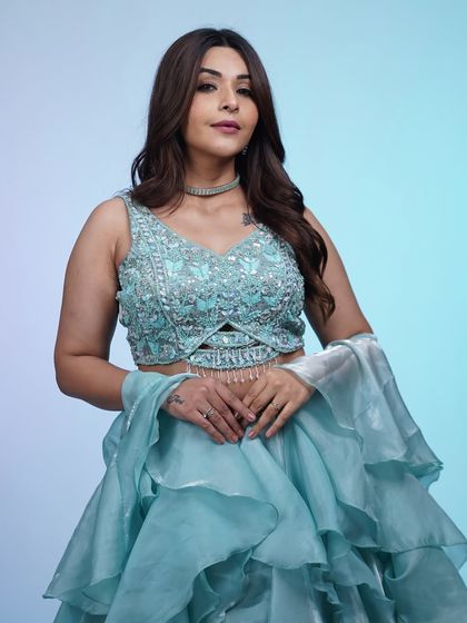 A closer look at the sequined blouse and ruffled skirt of this dreamy sky-blue lehenga. It’s a perfect blend of modern trends and traditional grace.