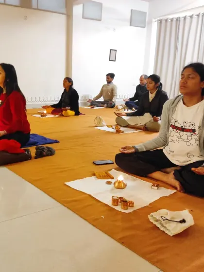 A participant sits in meditation after the Bhuta Shuddhi practice, her face serene and centered.
