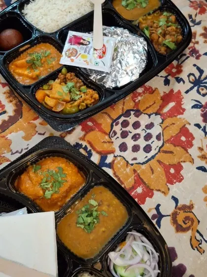 This is a sample of my homestyle lunch thali, perfect for corporate orders or events. This particular meal includes shahi paneer, dal, mix veg, chole, jeera rice, roti, and a gulab jamun, offering a complete and satisfying 'ghar ka khana' experience.