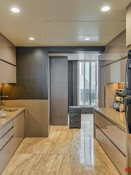 An acrylic parallel kitchen design that creates a sleek and modern cooking space.