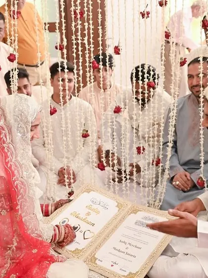 The heart of the Nikkah ceremony, as the couple sits before the officiant with their families. This image documents the solemn and traditional aspects of an Islamic wedding.