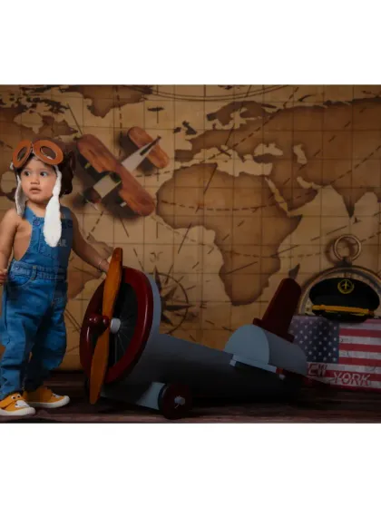 A future aviator standing by his plane. Our creative setups are designed to inspire play and capture your child's personality.
