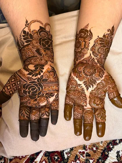 A gorgeous design featuring a large, bold rose on one hand and a flowing vine pattern on the other.