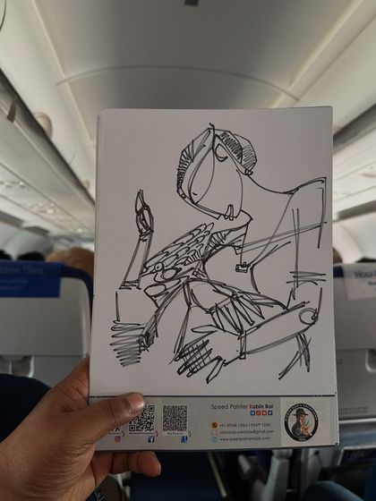 A pen sketch of a person playing a pizza-like drum, created on my sketchbook while traveling.