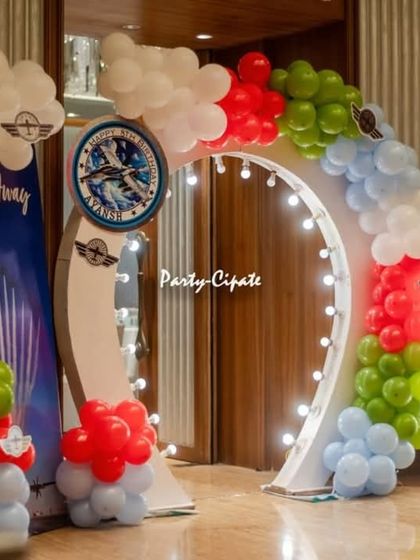 Another angle of the entrance arch, showing the 'Up, Up & Away' sign and the colorful balloon garland.