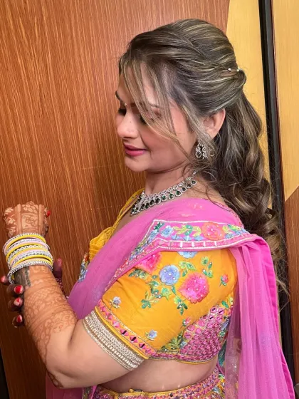A lovely client in a bright yellow and pink lehenga. Her makeup is fresh and pretty, perfect for a daytime event.