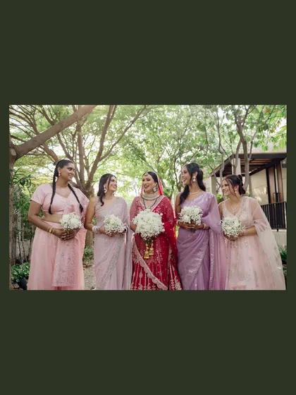 A classic portrait of the bride with her bridesmaids, all smiles and holding their bouquets. A beautiful memory of the women who stood by her side.