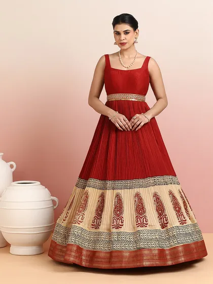 I designed this floor-length gown as a seamless blend of traditional motifs and contemporary form. The rich red pleated bodice flows into a beige skirt adorned with classic paisley embroidery, making it an elegant choice for receptions and formal evening soirées.