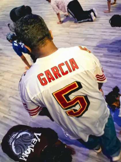 Students stretching and warming up during the Collab Series 2.0. Every class starts with preparation to ensure a safe and effective session.