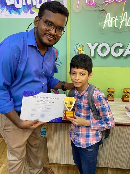 Celebrating every participant is important. Here, another young chess player is recognized for his efforts in the tournament.