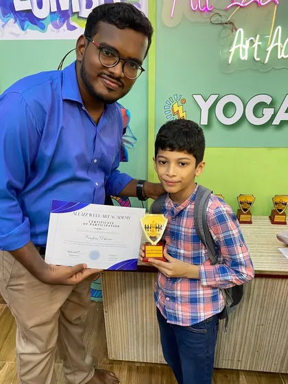 Celebrating every participant is important. Here, another young chess player is recognized for his efforts in the tournament.