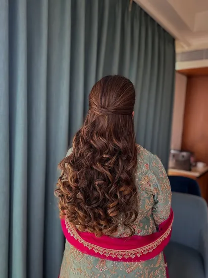 A full back view of the half-updo with curls, a versatile look for any celebration.