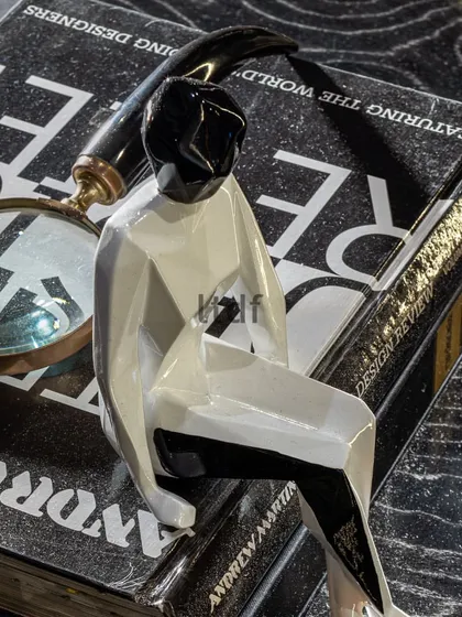 Our partnership with Quba Homes was about telling stories through design. This small decor piece, a reading figure, subtly conveys aspirations and a desirable lifestyle, reflecting the collection's blend of classic style with modern elements.