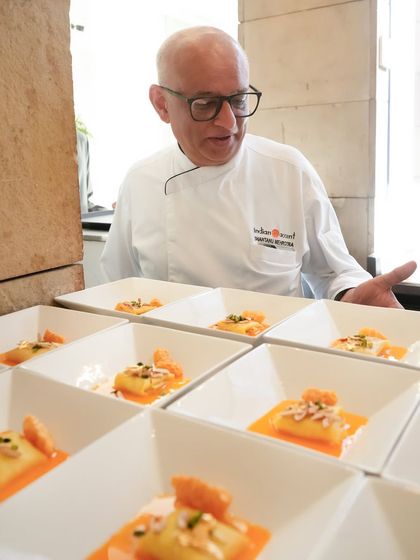 Chef Shantanu Mehrotra oversees the plating of our take on the classic malpua. Soft as a sigh and soaked in citrus, it delicately balances Indian indulgence with French restraint.