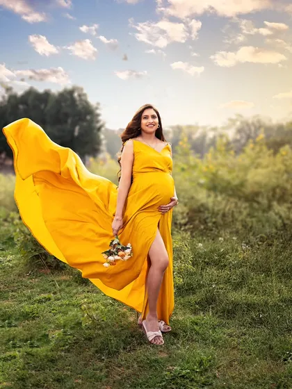 There's a special magic in the golden hour, where the warm sunlight paints everything with a dreamy glow. This outdoor session captures the serene beauty of motherhood in a natural, open space.