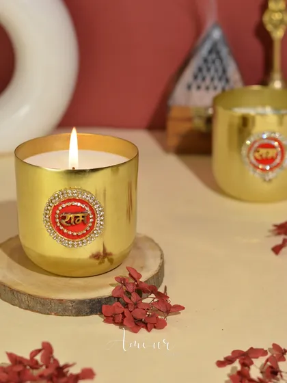 The Shri Ram candle, set in a golden jar with a decorated emblem, brings a sense of peace and devotion to any space.