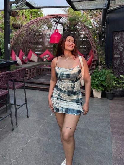 A happy, relaxed pose in the stylish summer dress.