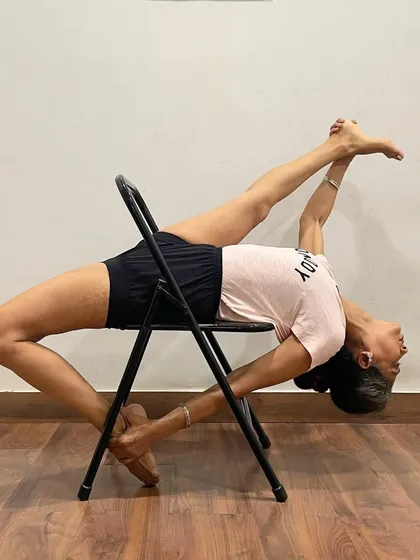 Eka Pada Rajakapotasana (One-Legged King Pigeon Pose) is explored here with the support of a chair. The chair helps to open the hip flexors and create the backbend without collapsing, making this advanced pose more attainable.