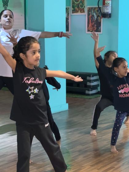 A group of young dancers learning to move in unison. The focus and teamwork in our beginner classes are wonderful to see.