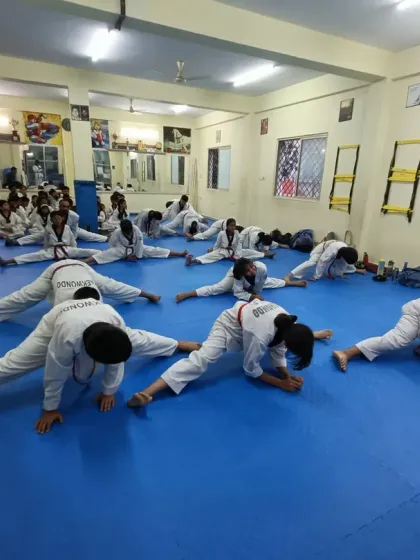 Flexibility is key to powerful kicks. Here, students work on their side splits, an essential part of our conditioning routine.