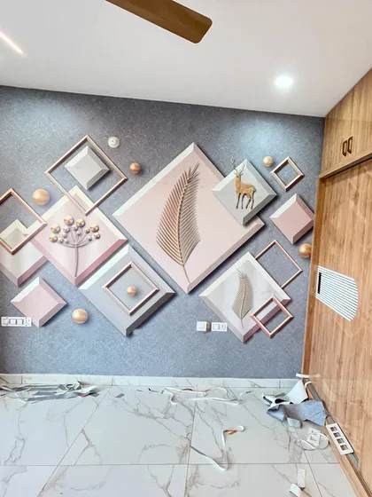 The aftermath of a successful installation. This image shows the finished geometric wallpaper, with the protective paper scraps on the floor, ready for cleanup.