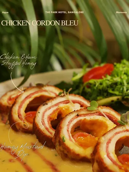 Chicken Cordon Bleu, elegantly sliced and served with a creamy honey mustard dip. A classic European dish perfected by my chefs.