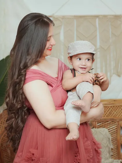 A sweet, playful moment between a mother and her son. We use props like this little cap to add a touch of personality to the shoot.