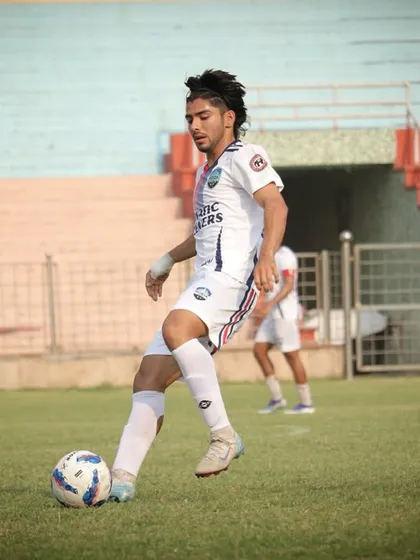 A senior player in action, controlling the ball with precision during our first match.