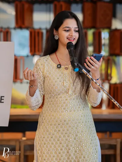 A poet shares her verses from her phone at a Sunday meetup. Whether your words are scribbled on a napkin or saved in your notes app, our stage is ready for you.