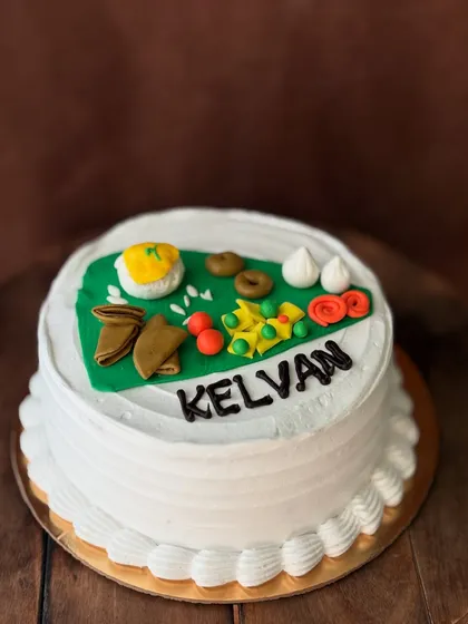 A special custom cake for a 'Kelvan' ceremony, a pre-wedding Maharashtrian ritual. The top features edible miniatures of traditional food items served during the function.