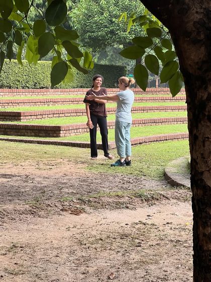 A candid conversation in the beautiful, terraced gardens of the retreat center. These moments of connection and sharing are an integral part of the community experience.