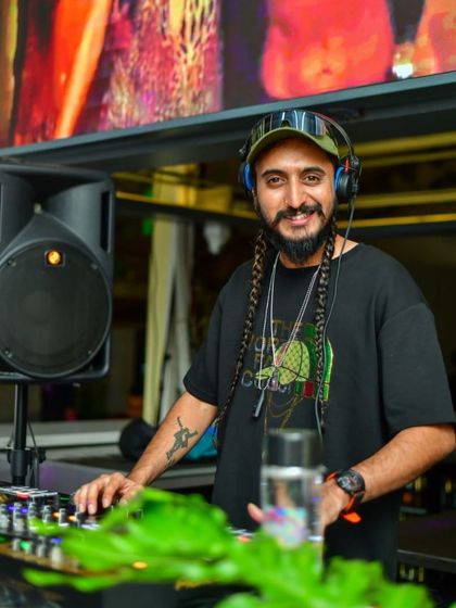 A calm moment behind the decks, with my headphones on, ready to mix. Music is a beautiful thing, and I let it flow through me.